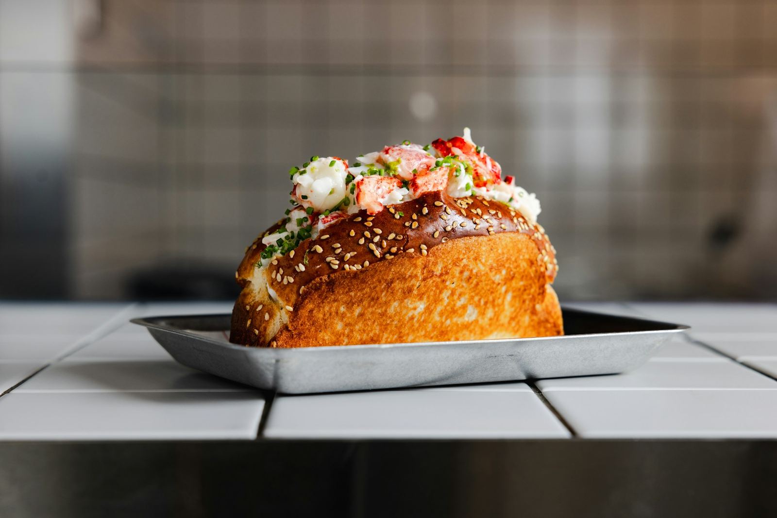 Buttered lobster roll on a toasted split-top bun, heaped with claw and knuckle meat
