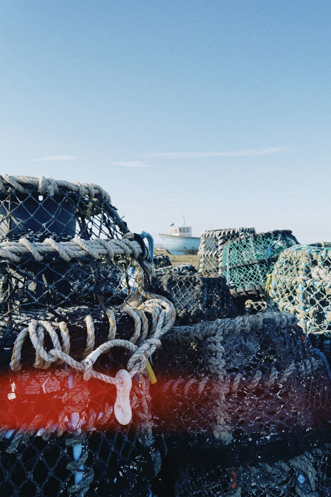 Stacked lobster traps with rope and floats on the dock